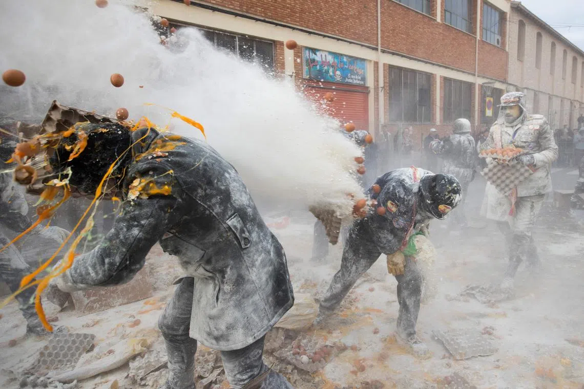 Revellers dressed in mock military garb taking part in the "Els Enfarinats" battle in the southeastern Spanish town of Ibi on Dec 28, 2023. 
