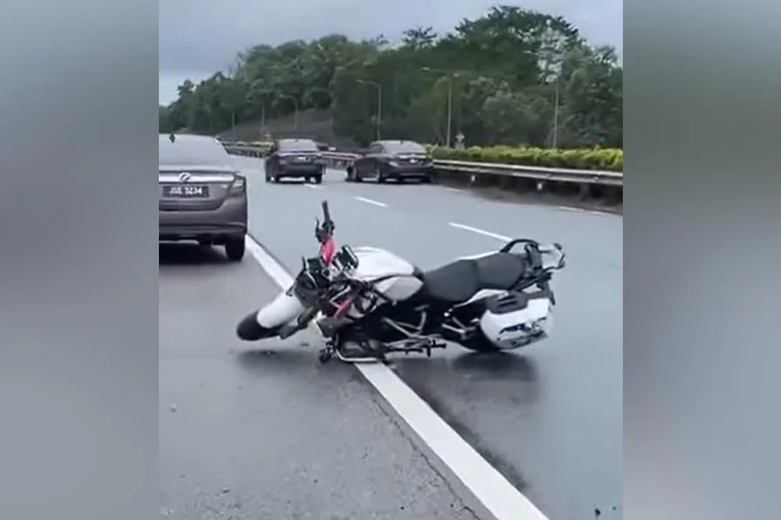 The motorcycle the man was riding left on the road after the accident on the highway in Johor.