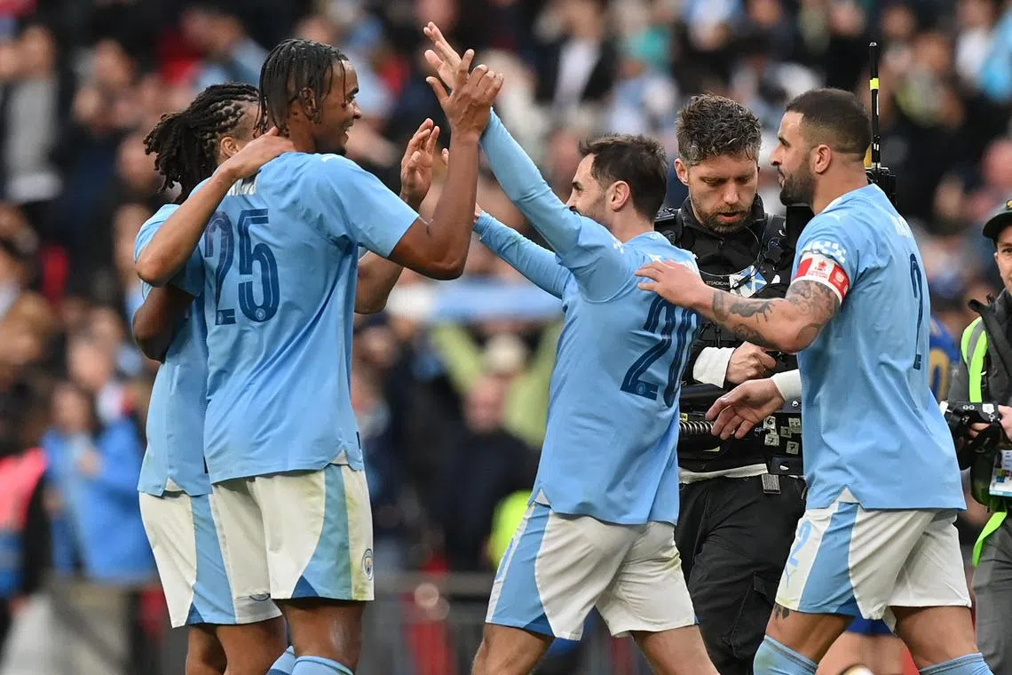 Manchester City midfielder Bernardo Silva (centre, right) celebrates with teammates after the match.