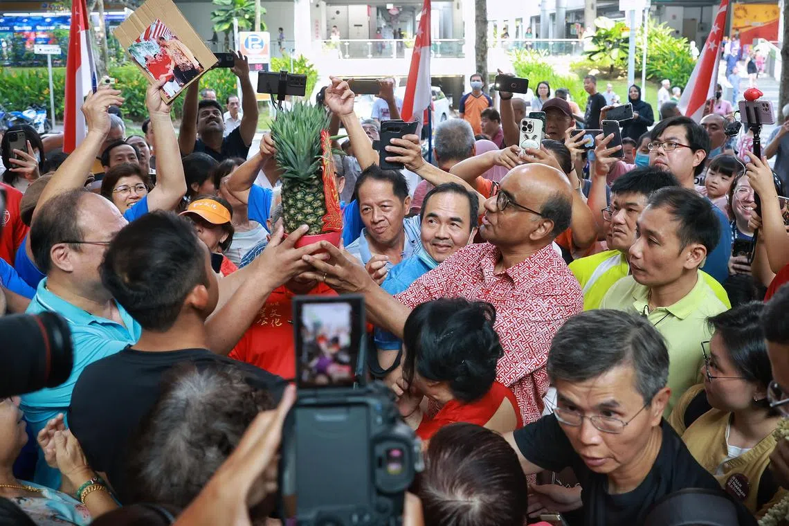 President-elect Tharman Shanmugaratnam receiving a pineapple from a supporter at Taman Jurong Market and Food Centre, 2 September 2023. 