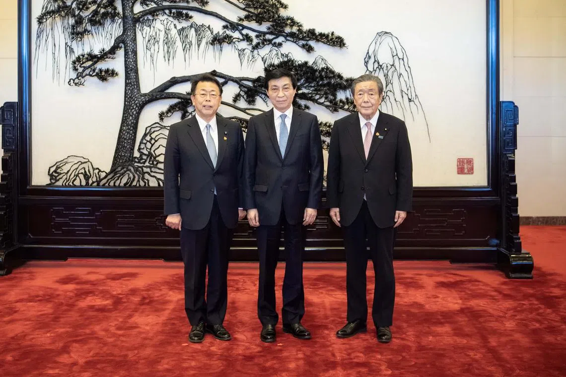 Mr Wang Huning (centre), member of the Standing Committee of the Political Bureau of the Chinese Communist Party Central Committee, meets with a delegation of Japan's ruling coalition including Liberal Democratic Party secretary-general Hiroshi Moriyama (right) and Komeito secretary-general Makoto Nishida (left) on Jan 14, 2025.