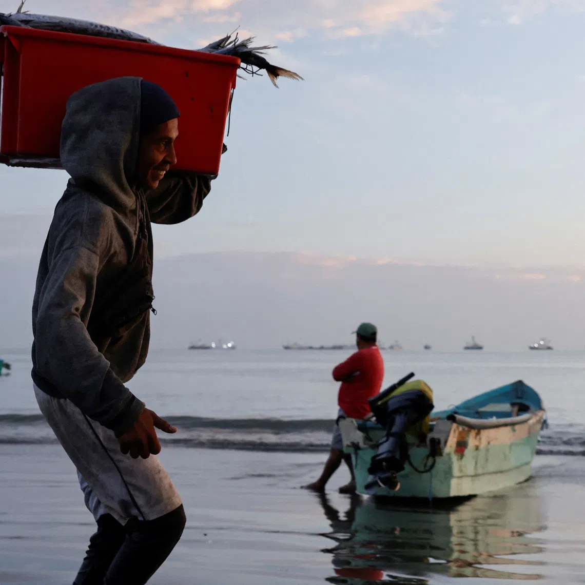 Fishermen unload their fresh catch near a market as local fishermen are increasingly being pursued by Ecuadorean gangs to move drugs and for their skills navigating the Pacific waters along Ecuador's coast, which has become a hub for the international smuggling of narcotics over the last half-decade, in Manta, Ecuador, June 4, 2026. REUTERS/Karen Toro