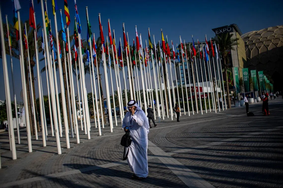 epa11011756 A participant walks at Expo City Dubai, the venue of the 2023 United Nations Climate Change Conference (COP28), in Dubai, United Arab Emirates, 05 December 2023. The 2023 United Nations Climate Change Conference (COP28), runs from 30 November to 12 December, and is expected to host one of the largest number of participants in the annual global climate conference as over 70,000 estimated attendees, including the member states of the UN Framework Convention on Climate Change (UNFCCC), business leaders, young people, climate scientists, Indigenous Peoples and other relevant stakeholders will attend.  EPA-EFE/MARTIN DIVISEK