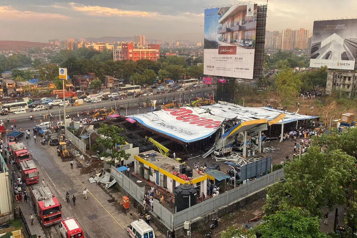 An aerial view shows a fallen billboard on a fuel station following a wind and dust storm in Mumbai, India, May 13, 2024. REUTERS/Prashant Waydande