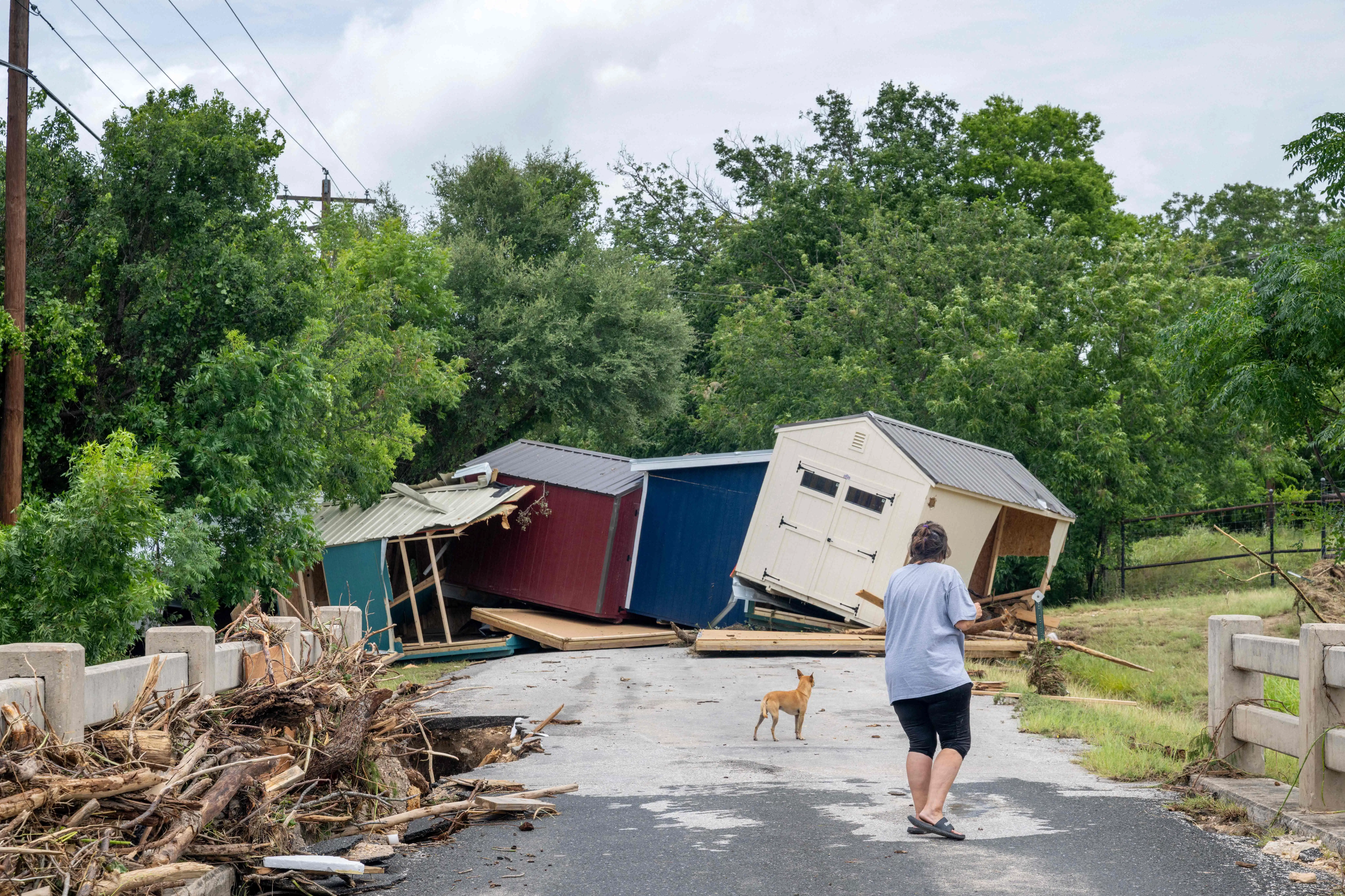 KERRVILLE, TEXAS - JULY 17: A person assess flood damage near the banks of the Guadalupe River on July 17, 2026 in Kerrville, Texas. Flash floods swept across parts of Central Texas, bringing torrential rainfall, prompting evacuations, and triggering hundreds of water rescues. At least two people have been killed, and more than 200 others have been rescued.   Brandon Bell/Getty Images/AFP (Photo by Brandon Bell / GETTY IMAGES NORTH AMERICA / Getty Images via AFP)