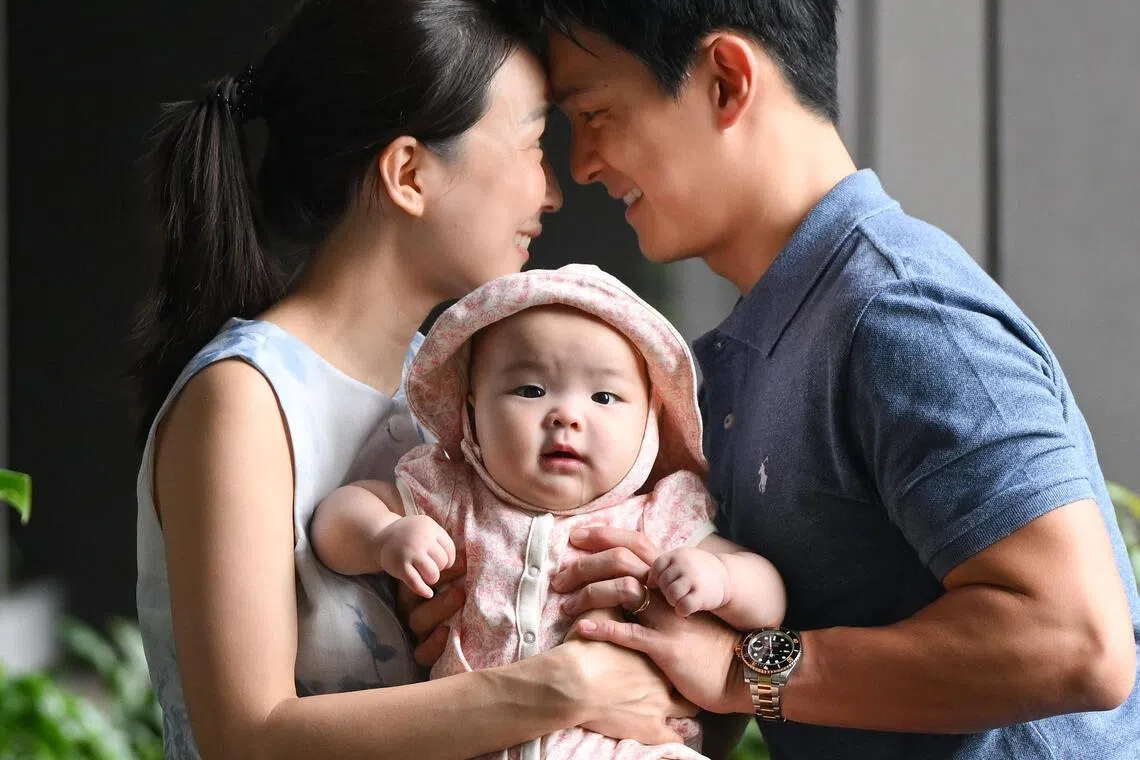 Singapore Armed Forces fighter pilot Gary Liang, 38, with his wife, Dorcas Lim, 38, and their six-month-old baby Olivia Liang, at the roof garden of their condominium in Lentor on July 12.