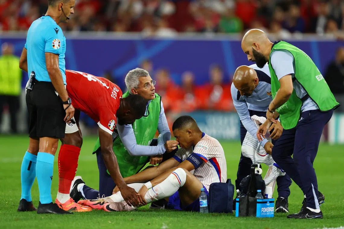 Soccer Football - Euro 2024 - Group D - Austria v France - Dusseldorf Arena, Dusseldorf, Germany - June 17, 2024 France's Kylian Mbappe receives medical attention after sustaining an injury REUTERS/Kacper Pempel