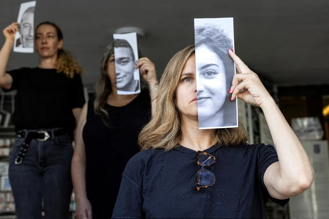 Relatives and supporters holding pictures of hostages kidnapped during the deadly October 7 attack on Israel by the Palestinian Islamist group Hamas, during a performance calling for their return, in Tel Aviv, Israel, on May 23, 2024. 