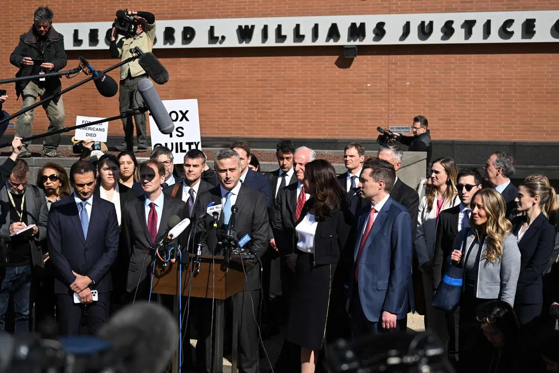 Dominion CEO John Poulos, joined by members of his legal team, speaks to members of the media.