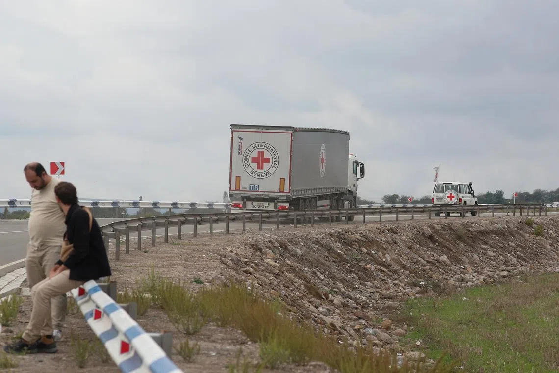 FILE PHOTO: Vehicles of the International Committee of the Red Cross (ICRC) transporting humanitarian aid for residents of Nagorno-Karabakh drive towards the Armenia-Azerbaijan border along a road near the village of Kornidzor, Armenia, September 23, 2023. REUTERS/Irakli Gedenidze/File Photo