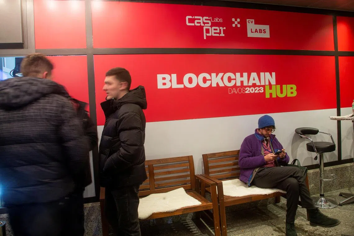 People stand in front of the Blockchain Hub Davos 2023 at the Promenade road during the World Economic Forum (WEF) 2023, in the Alpine resort of Davos, Switzerland, January 18, 2023. REUTERS/Arnd Wiegmann