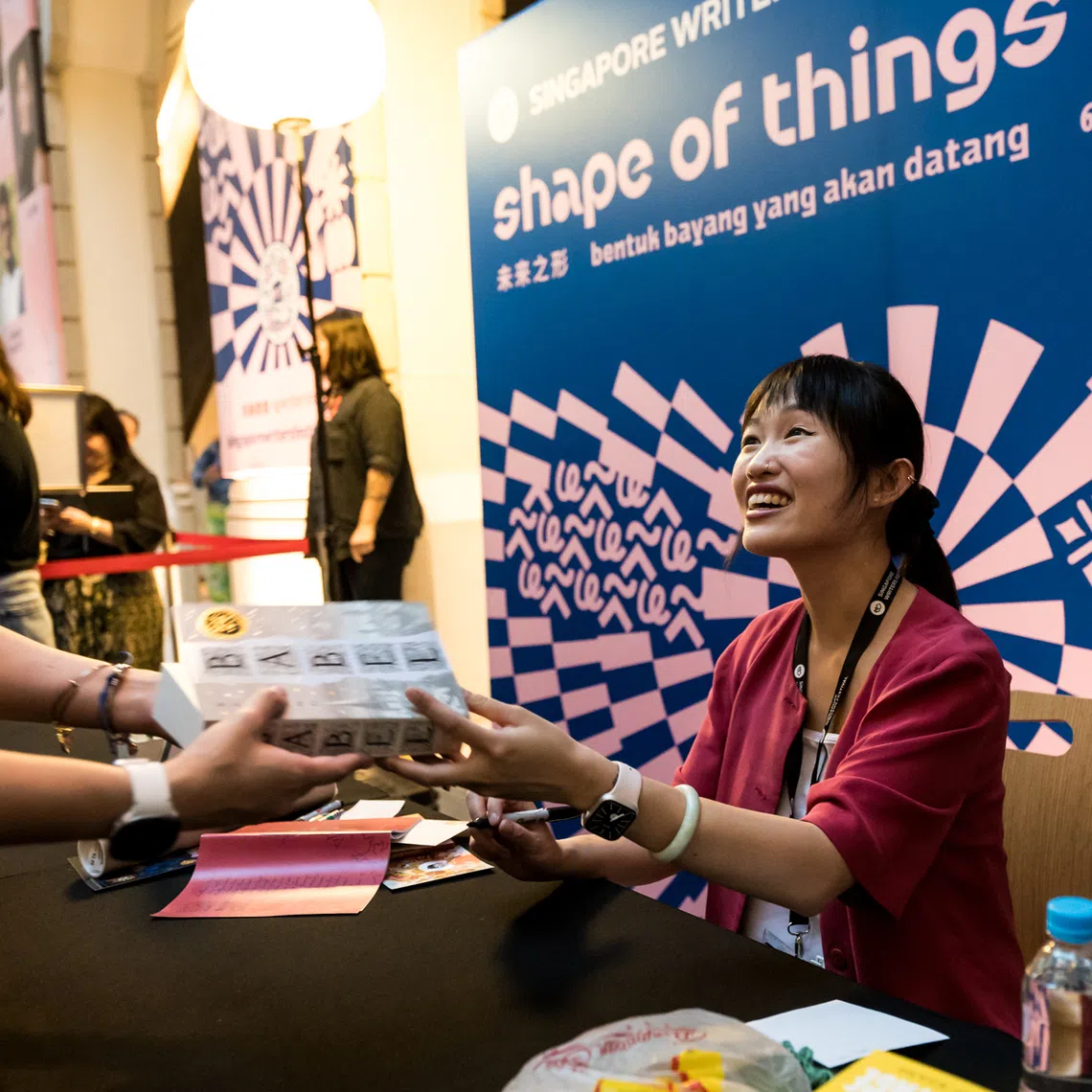 R. R. Kuang signing books after her keynote lecture. 