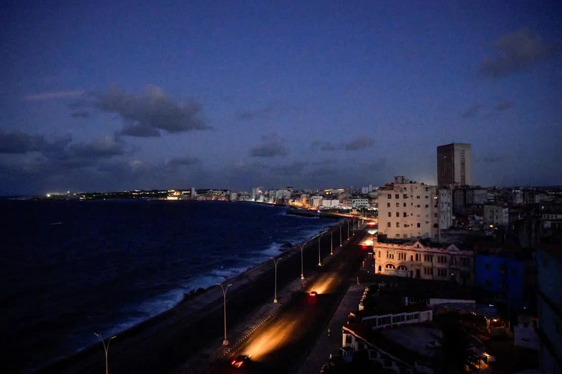 FILE PHOTO: Cars drive on Havana's seafront boulevard Malecon as the country's electrical grid collapsed again on Sunday, according to Cuba's energy and mines ministry, in the latest setback to the government's efforts to restore power to the island, in Havana, Cuba October 20, 2024. REUTERS/Norlys Perez/File Photo