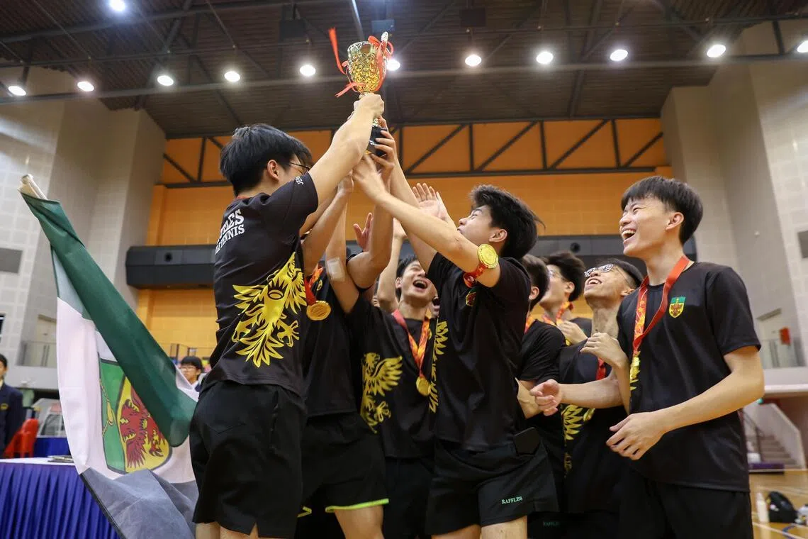 Players from Raffles Institution celebrating after receiving their gold medals and trophy for winning the National School Games A Division boys’ table tennis final. 