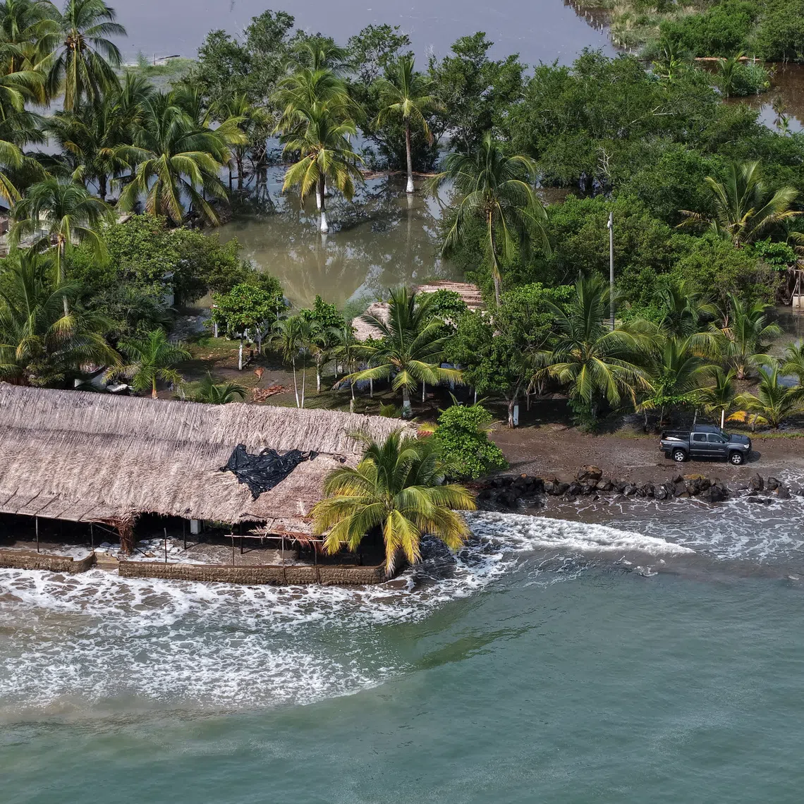 A drone view shows a flooded area affected by elevated tides caused by Hurricane Polo in San Blas, Nayarit, Mexico, September 26, 2026. REUTERS/Christian Ruano
