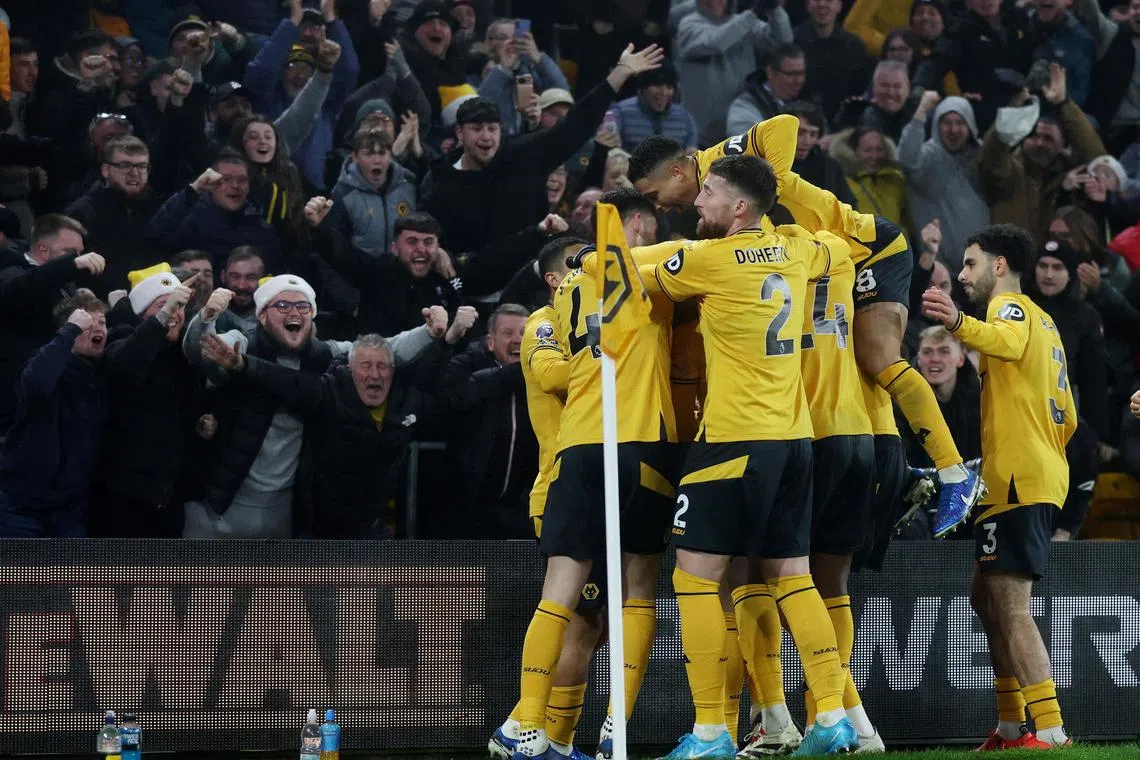 Wolverhampton Wanderers players celebrating after scoring against Manchester United in their 2-0 Premier League win.