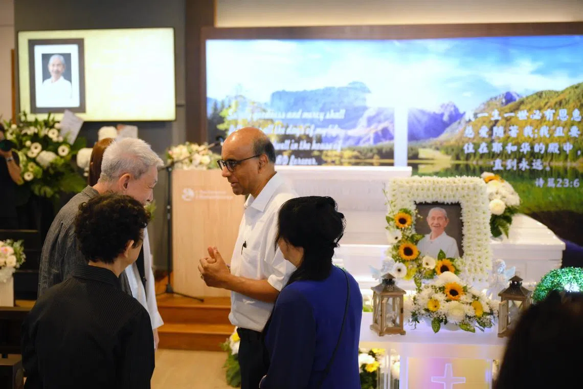 President Tharman Shanmugaratnam (centre) and his wife Ms Jane Ittogi (right), speak with family members of the late artist Lim Tze Peng, including his eldest son Lim Su Kok (far left), during his wake held at The Garden of Rememberance on Feb 5, 2025.