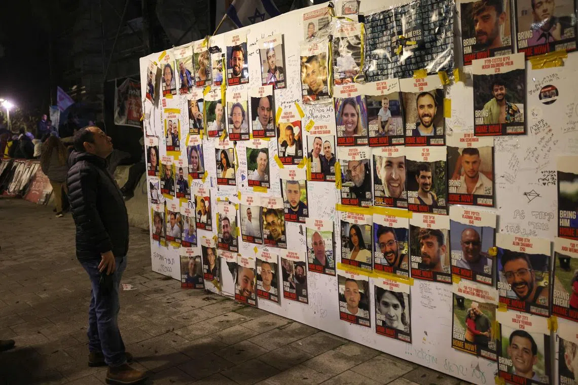 People look at portraits of Israeli hostages held in Gaza since the Oct 7 raid by Hamas on southern Israel.