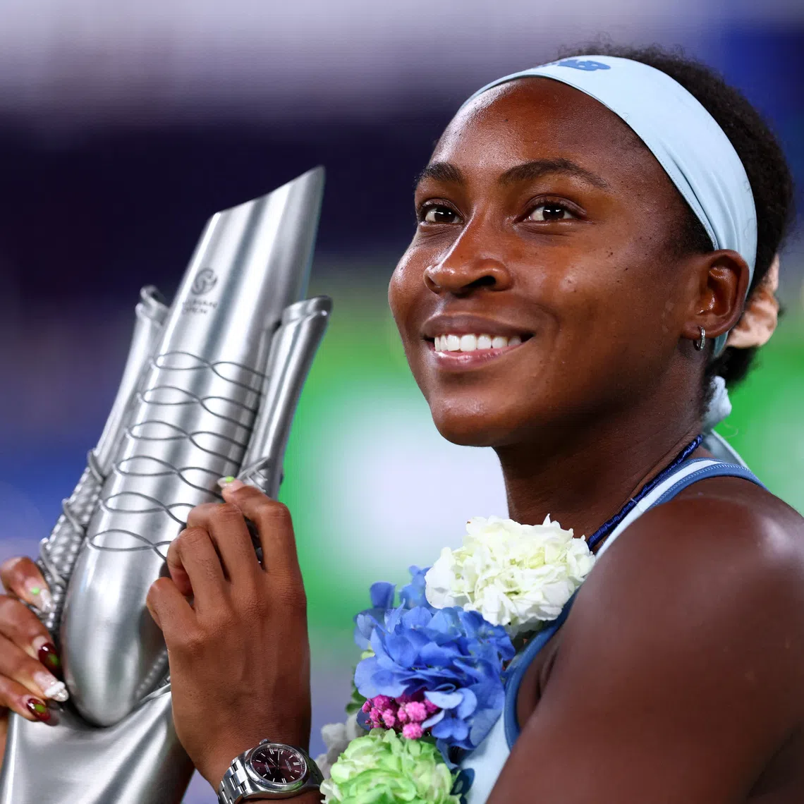 Tennis - WTA 1000 - Wuhan Open - Optics Valley International Tennis Center, Wuhan, China - October 12, 2025 Coco Gauff of the U.S. celebrates with the trophy after winning the final against Jessica Pegula of the U.S. REUTERS/Tingshu Wang
