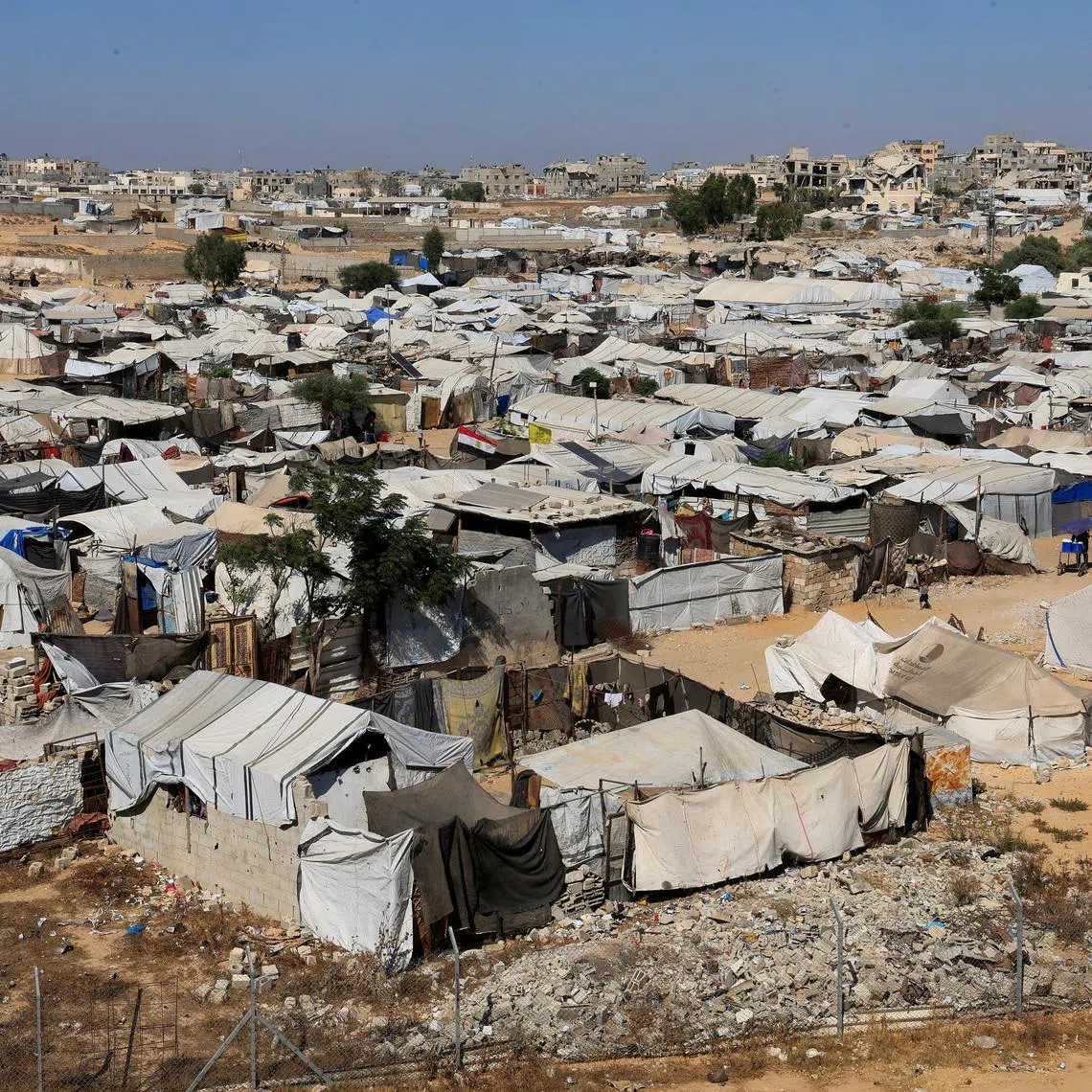 FILE PHOTO: Displaced Palestinians shelter at a tent camp in Khan Younis, southern Gaza Strip, July 8, 2026. REUTERS/Haseeb Alwazeer/File Photo