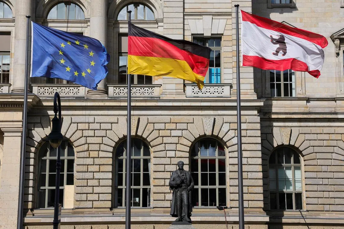 Flags of the European Union, Germany and Berlin flutter outside the Berlin state Parliament building. Germany enjoyed third-quarter growth of 0.2% - above analyst estimates.