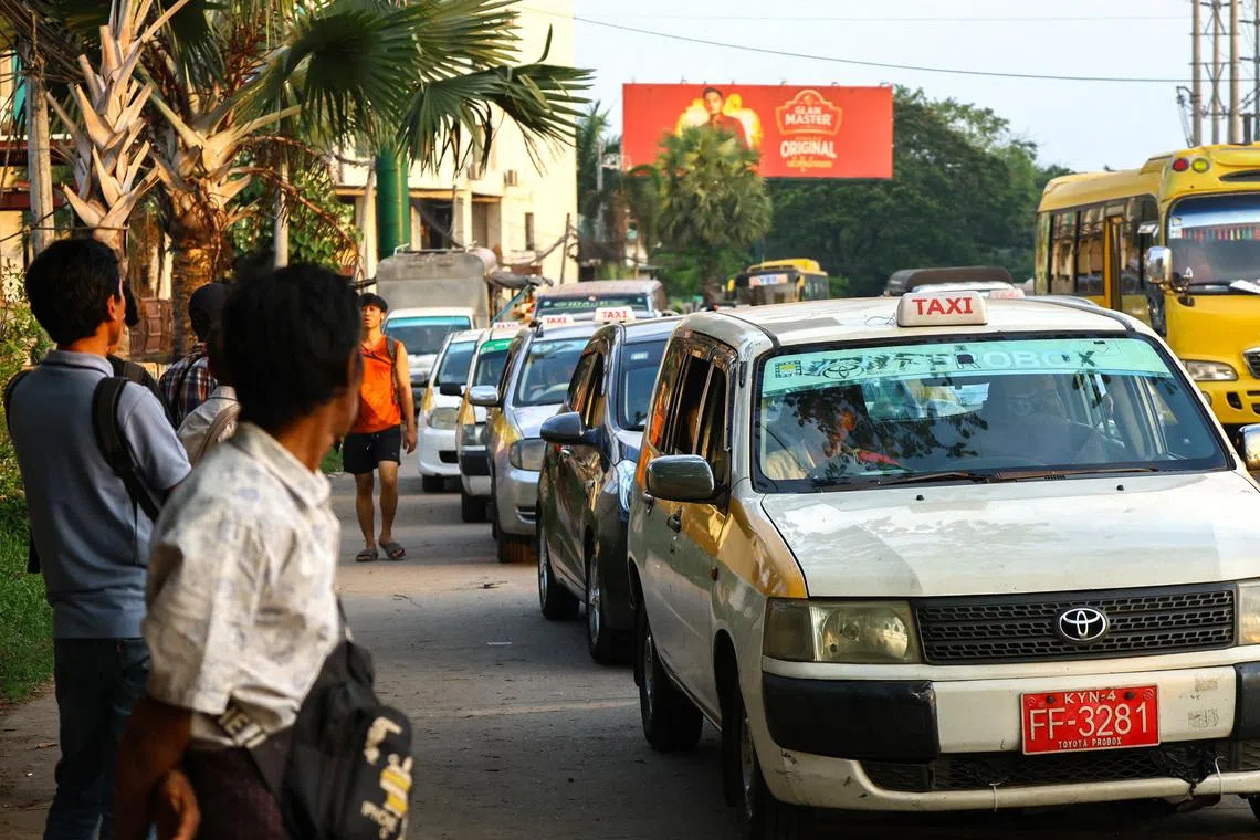 Drivers queue to fill fuel at a gas station in Yangon on March 20. Farmers in Myanmar also struggling with rising costs of diesel and fertilisers. 