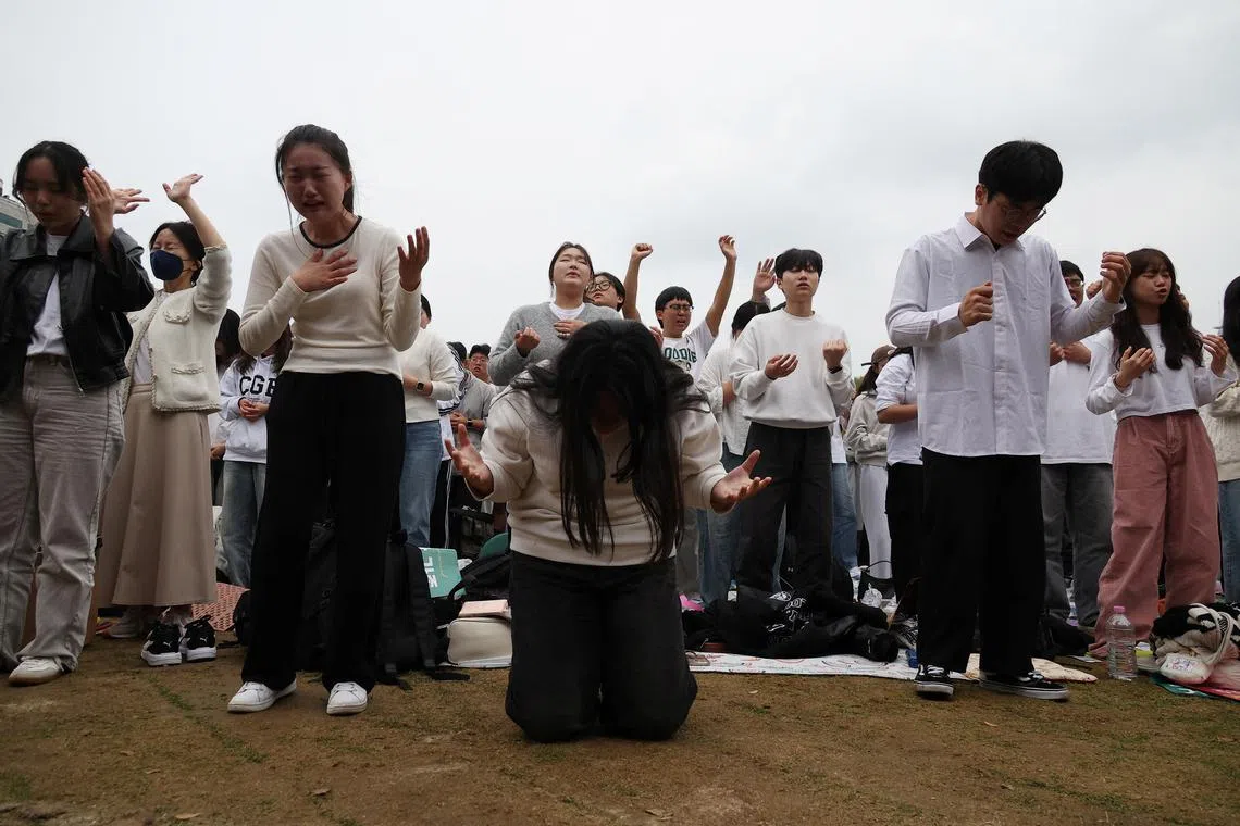 South Korean Christians pray during a massive worship service in protest of the legislation of anti-discrimination bills and same-sex relationships, in central Seoul, South Korea, October 27, 2024.     REUTERS/Kim Hong-Ji