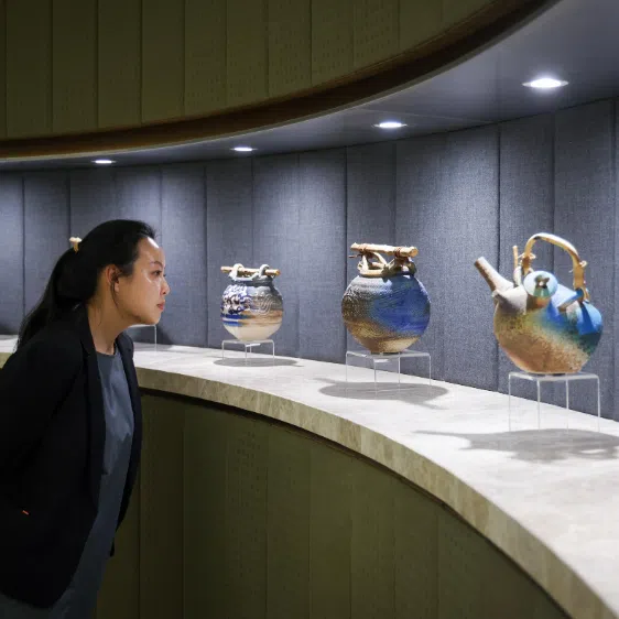 (Clockwise from top left) Vessels by Singapore ceramist Iskandar Jalil at WongPartnership, Suzanne Victor's work at Morgan Stanley, David Chan's The Grand History in UOB Plaza 1 and Kumari Nahappan's Saranggong at One Farrer Hotel.