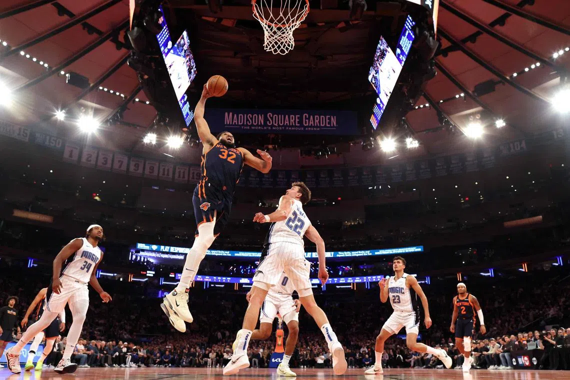Karl-Anthony Towns of the New York Knicks dunks against Franz Wagner of the Orlando Magic during their game at Madison Square Garden.
