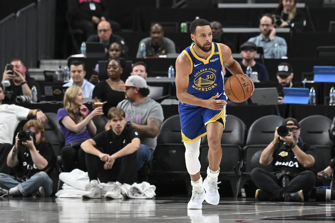 FILE PHOTO: Oct 15, 2024; Las Vegas, Nevada, USA; Golden State Warriors guard Stephen Curry (30) dribbles up the court against the Los Angeles Lakers in the first quarter during a preseason game at T-Mobile Arena. Mandatory Credit: Candice Ward-Imagn Images/File Photo