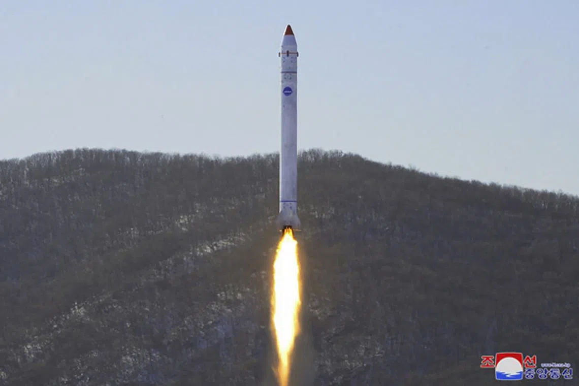 A rocket carrying an experimental satellite as it is launched from the Sohae Satellite Launch Ground in Tongchang-ri on Dec 19.