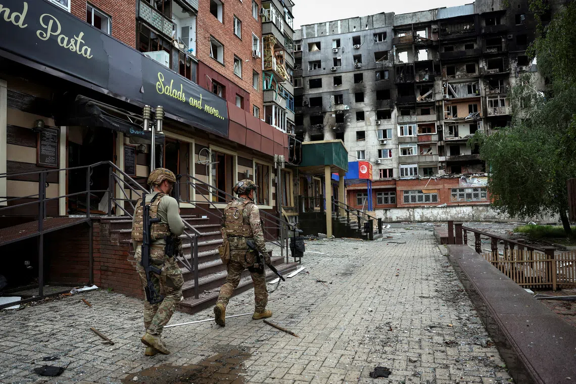 FILE PHOTO: Members of the White Angel unit of Ukrainian police officers who evacuate people from the frontline towns and villages, check an area for residents, amid Russia's attack on Ukraine, in the frontline town of Pokrovsk in Donetsk region, Ukraine May 21, 2025. REUTERS/Anatolii Stepanov/File Photo