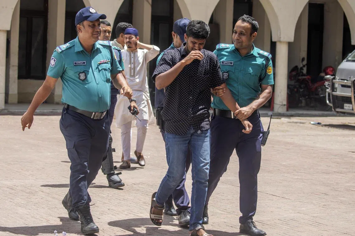 angladesh police arrest a man in front of a mosque as people attend Friday prayers in Dhaka, Bangladesh.