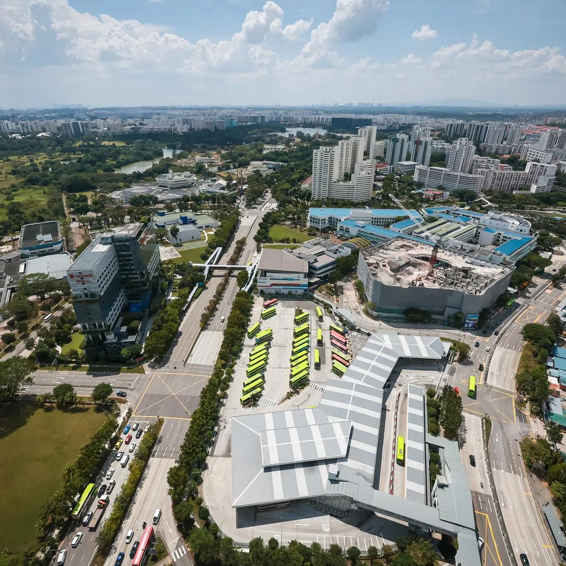 Three plots of land for a new precinct in the Jurong Lake District, March 26, 2024. Plot 1 (left) - Greenery beside Genting Hotel Jurong. Plot 2 (centre) - The current Interim Jurong East Bus Interchange. Plot 3 (right) - Construction site beside Jurong East MRT Station.
