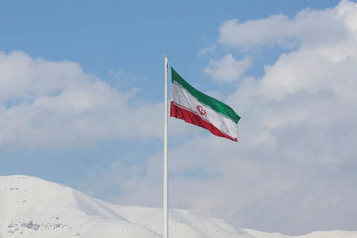The Iranian flag is seen flying over a street in Tehran, Iran, February 1, 2023. Majid Asgaripour/WANA (West Asia News Agency) via REUTERS/ File Photo