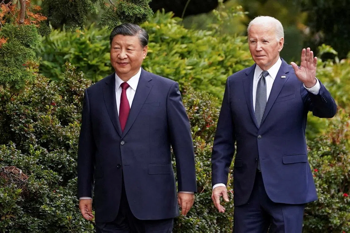 FILE PHOTO: U.S. President Joe Biden waves as he walks with Chinese President Xi Jinping at Filoli estate on the sidelines of the Asia-Pacific Economic Cooperation (APEC) summit, in Woodside, California, U.S., November 15, 2023. REUTERS/Kevin Lamarque//File Photo