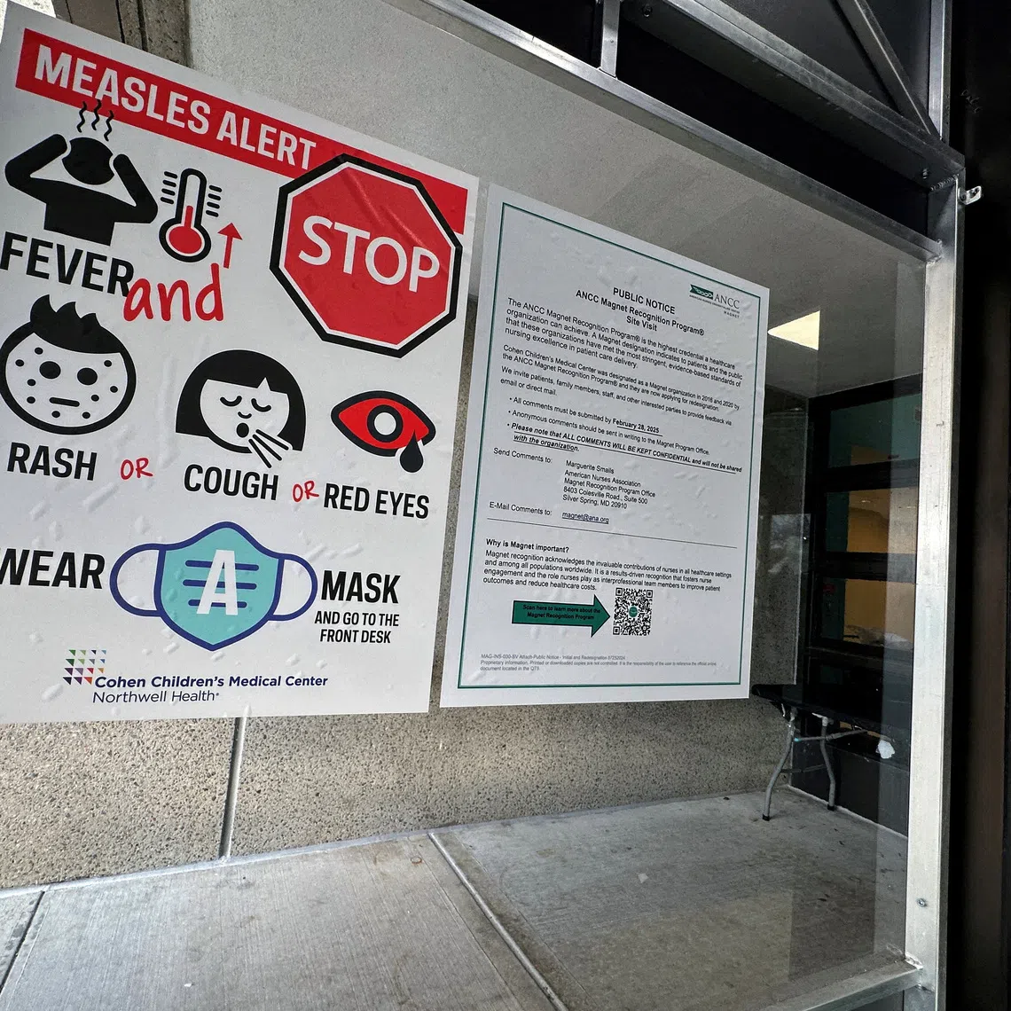 FILE PHOTO: A measles alert sign hangs outside the entrance to the Cohen Children's Medical Center in New Hyde Park, New York, U.S., March 14, 2025. REUTERS/Shannon Stapleton//File Photo