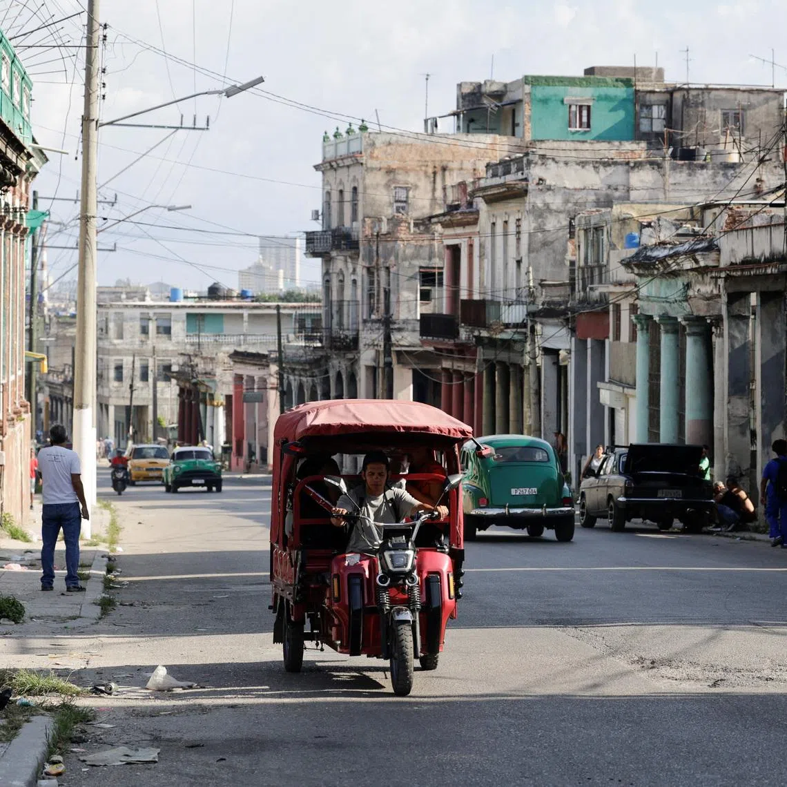 A man drives an electric rickshaw along an avenue as Cuba's electrical grid suffered a partial collapse early Thursday morning, cutting power across eastern Cuba amid a U.S. fuel blockade, in Havana, Cuba, May 14, 2026. REUTERS/Norlys Perez
