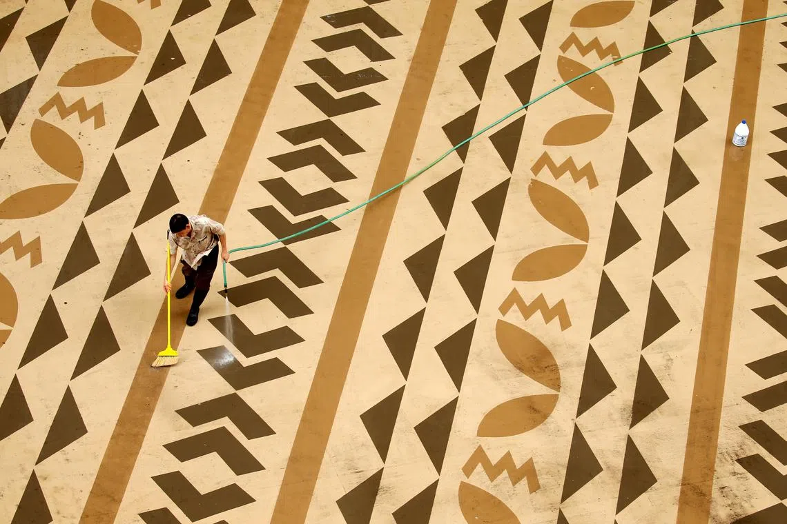 A worker cleans off a rooftop deck at a hotel on Waikiki Beach in Hawaii, U.S., December 30, 2016. REUTERS/Kevin Lamarque