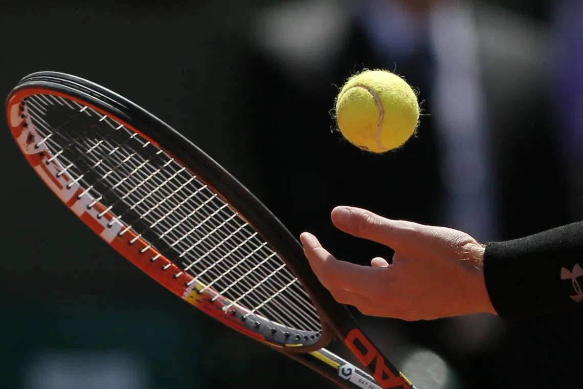 FILE PHOTO: A ball and the racket of Andy Murray of Britain are pictured as he prepares to serve to Novak Djokovic of Serbia during their men's semi-final match at the French Open tennis tournament at the Roland Garros stadium in Paris, France, June 6, 2015. REUTERS/Gonzalo Fuentes/File Photo