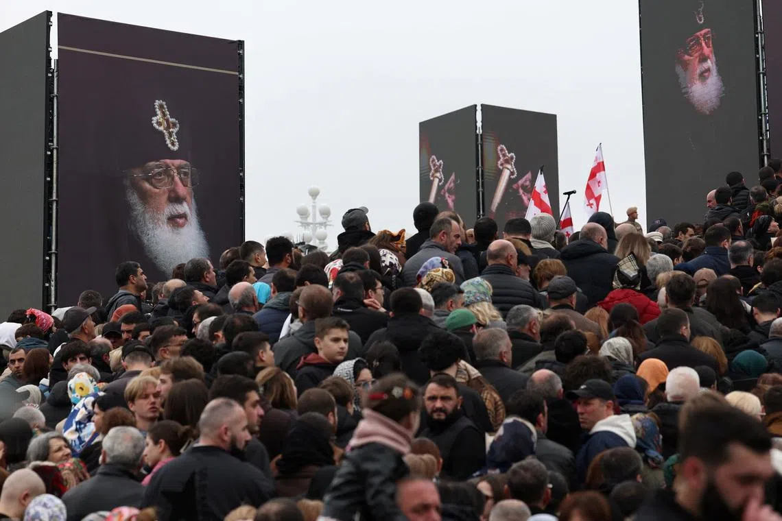 Mourners attend a funeral service of the late Georgia's Orthodox Patriarch Ilia II outside the Sameba Cathedral in Tbilisi, Georgia March 22, 2026. Giorgi Arjevanidze/Pool via REUTERS