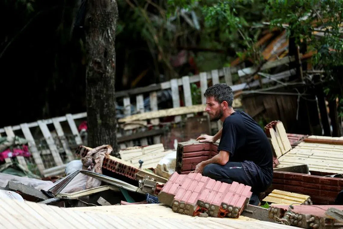 Flood survivor Miguel Rutigliano Bieleski looks at the wreckage of his house, as his wife Ariel Armani, his daughter Yasmin and his son Miguel Junior are still missing, after the passage of the extratropical cyclone that hit the region, Lajeado, Brazil September 8, 2023. PHOTO: REUTERS