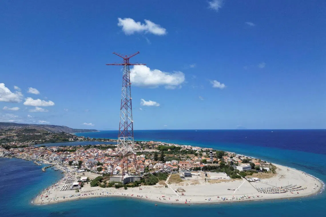 A drone view shows the Sicilian coast visible across the Strait of Messina, part of the planned site for construction of a suspension bridge connecting Sicily to mainland Italy, with construction expected to be completed in 2032, in Messina, Italy, August 6, 2025. REUTERS/Yara Nardi