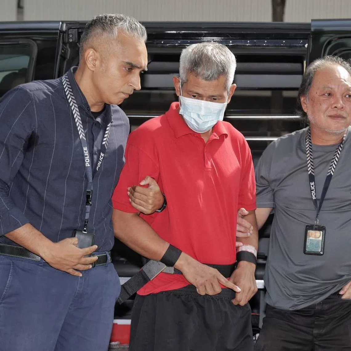 Police bringing the 49-year-old male suspect, who allegedly murdered a 35-year-old man on the morning of July 27, back to the crime scene at 803 Yishun Ring Road on Aug 6, 2024. 