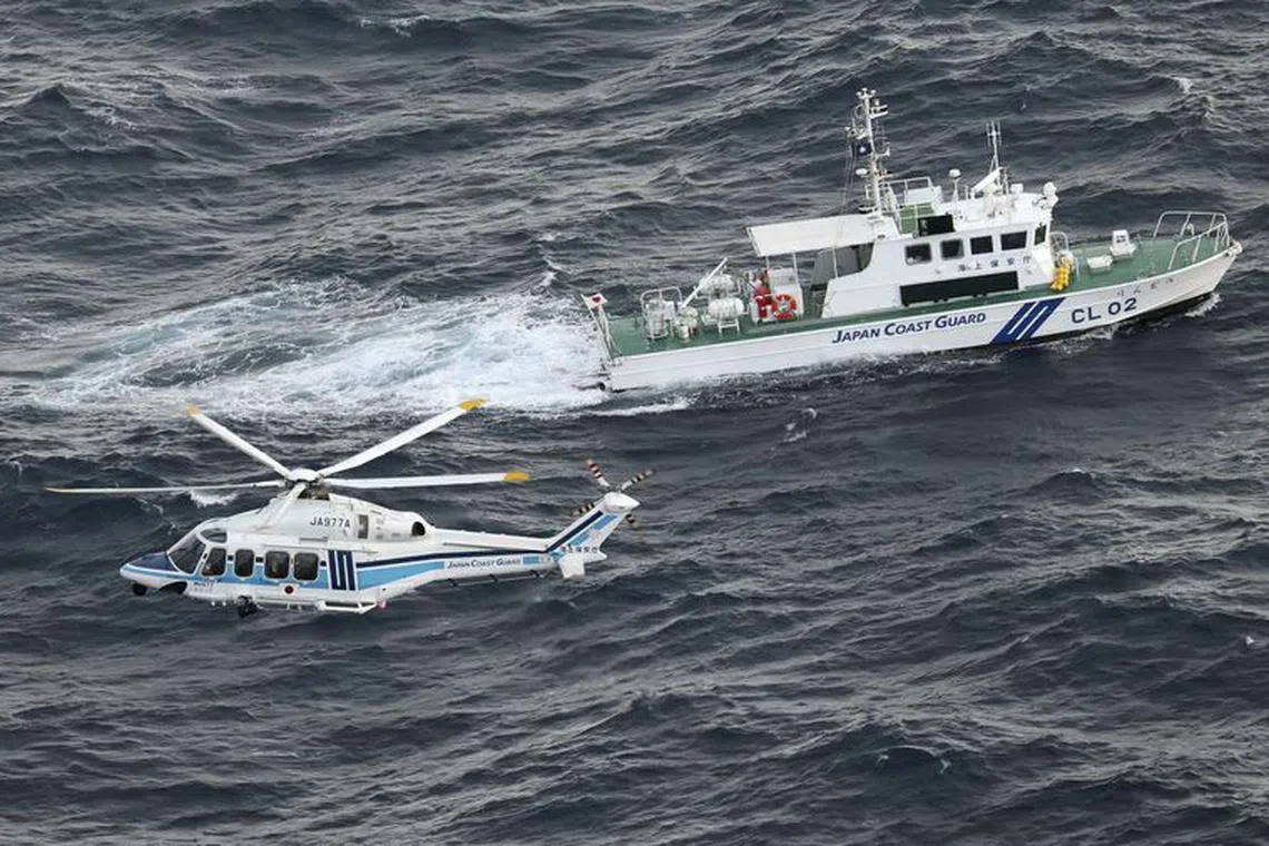 A Japan Coast Guard vessel and a helicopter conduct a search and rescue operation at the site where a U.S. military aircraft V-22 Osprey crashed into the sea off Yakushima Island, Kagoshima prefecture, Japan November 30, 2023, in this photo taken by Kyodo. Mandatory credit Kyodo via REUTERS