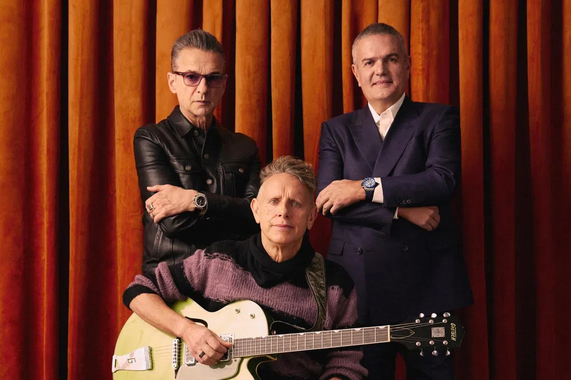 Depeche Mode's Martin Gore (seated) and Dave Gahan (background, left) with Hublot chief executive Ricardo Guadalupe.