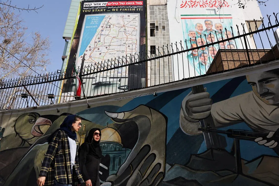 Iranian women walk past an anti-Israeli billboard in Tehran, Iran, February 19, 2026. Majid Asgaripour/WANA (West Asia News Agency) via REUTERS