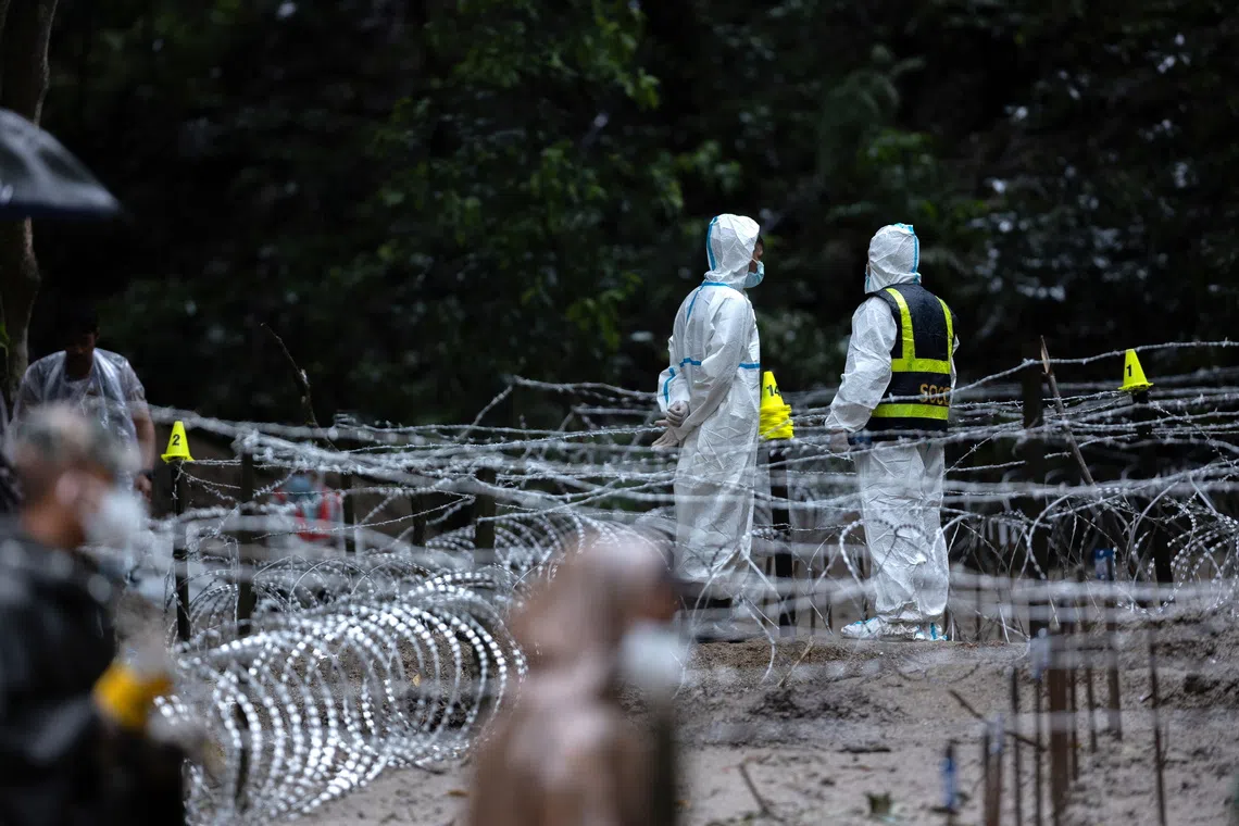 Barbed and razor wire cover the grave site of unidentified victims at Dakshin Dhoka, Gokarneshwor, in Nepal, on Sept 1.