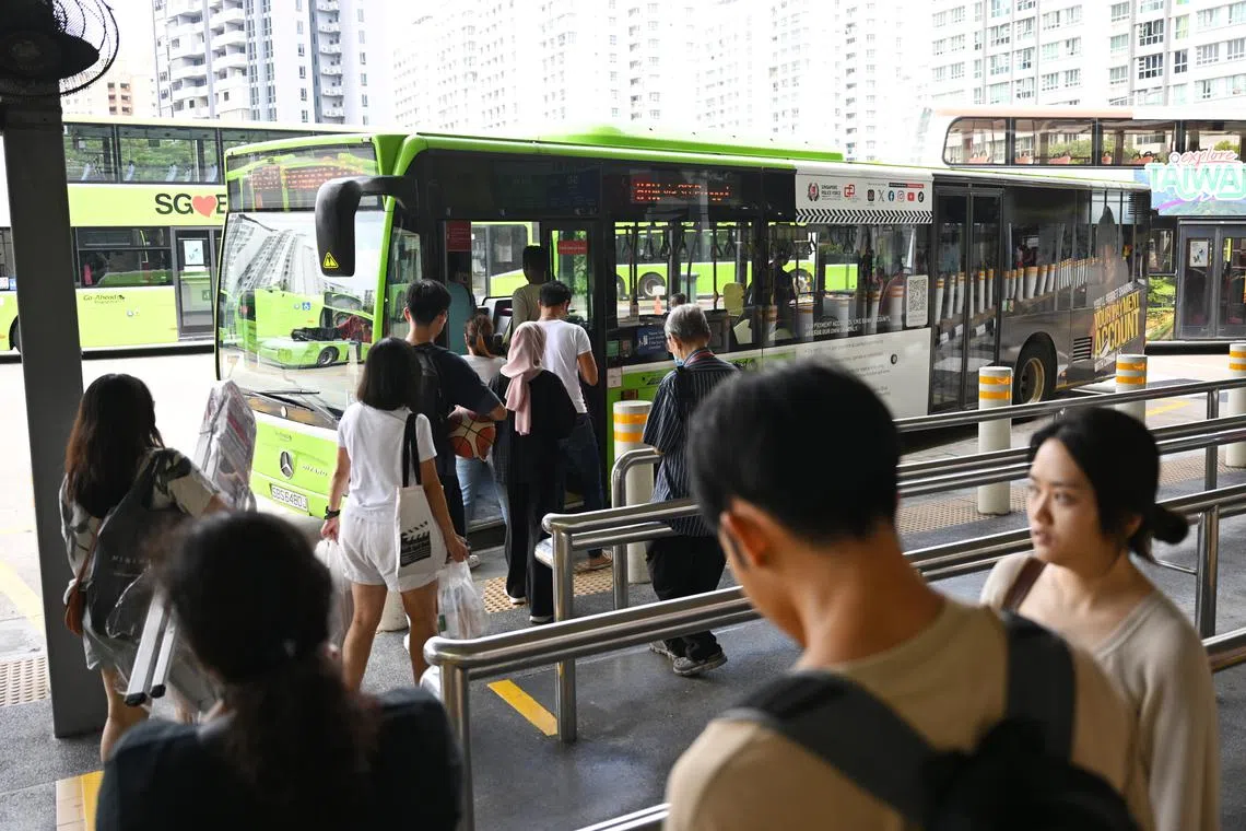 People boarding a bus at Punggol Bus Interchange on July 30, 2024.