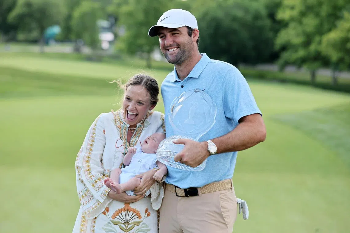 Scottie Scheffler posing with the trophy with wife Meredith and son Bennett after winning the Memorial Tournament.